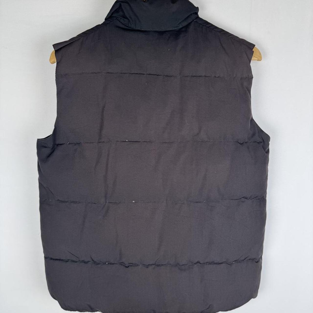 Canada Goose black down puffer gilet with logo patch and quilted texture.
