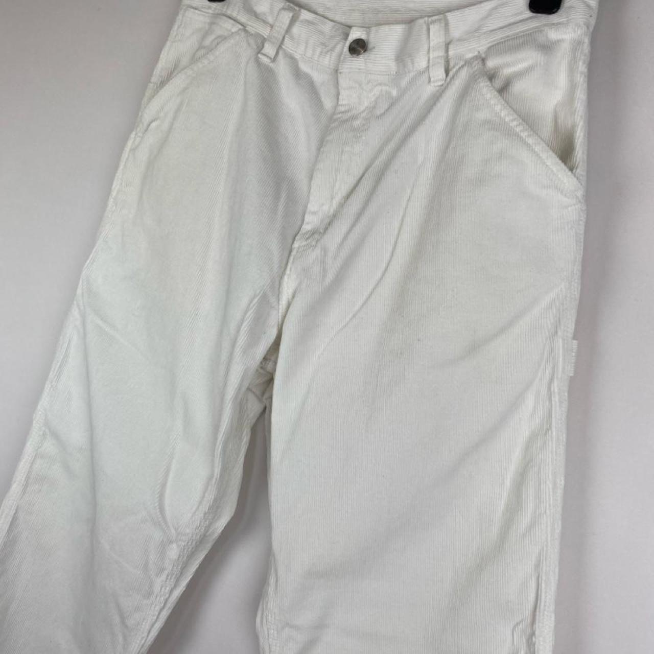 Carhartt WIP white corduroy carpenter trousers with single knee design and relaxed fit.