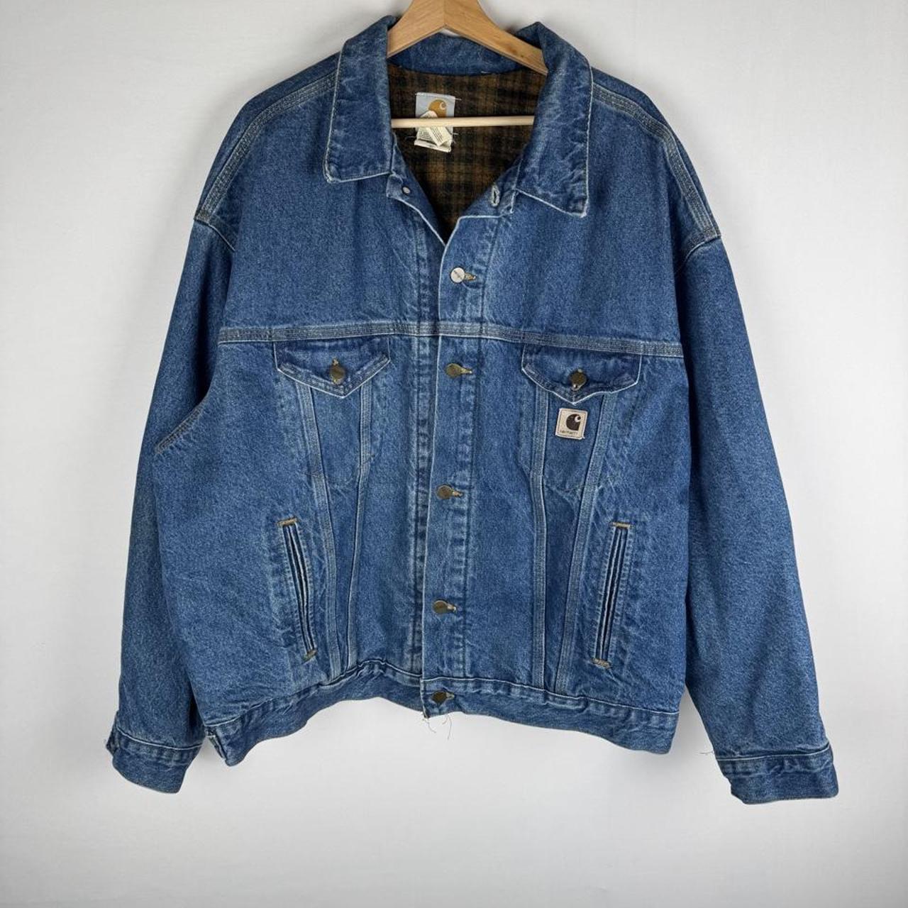 Carhartt denim trucker jacket 1990s style with classic logo and relaxed fit.