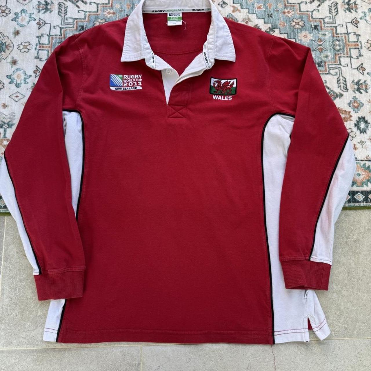 Wales red rugby polo shirt with embroidered logo and World Cup details.