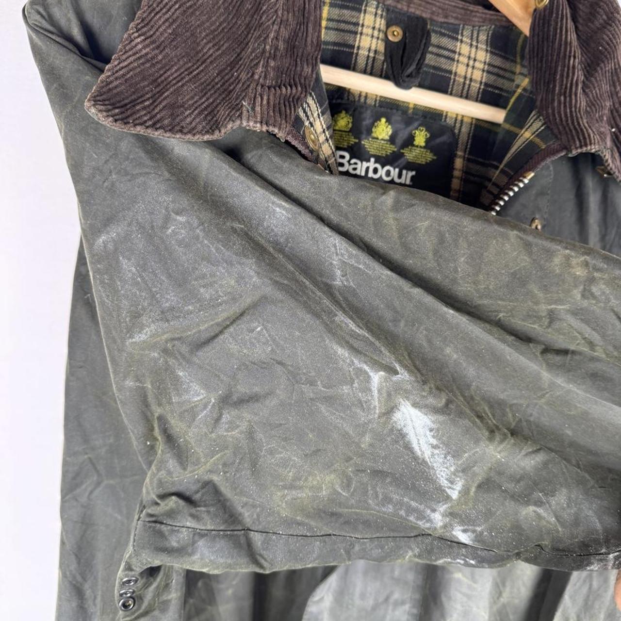 Barbour green waxed Beaufort jacket with attached hood and classic logo detail.