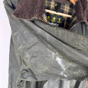 Barbour green waxed Beaufort jacket with attached hood and classic logo detail.