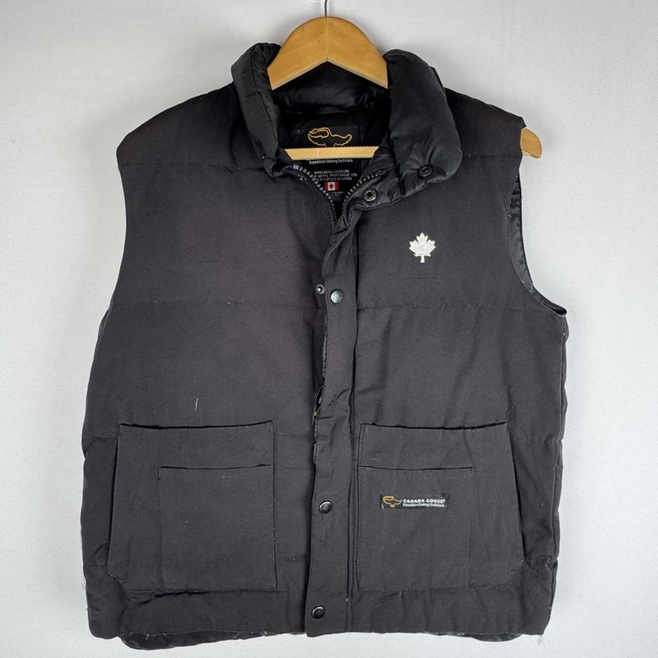 Canada Goose black down filled gilet with logo patch and zip pockets.