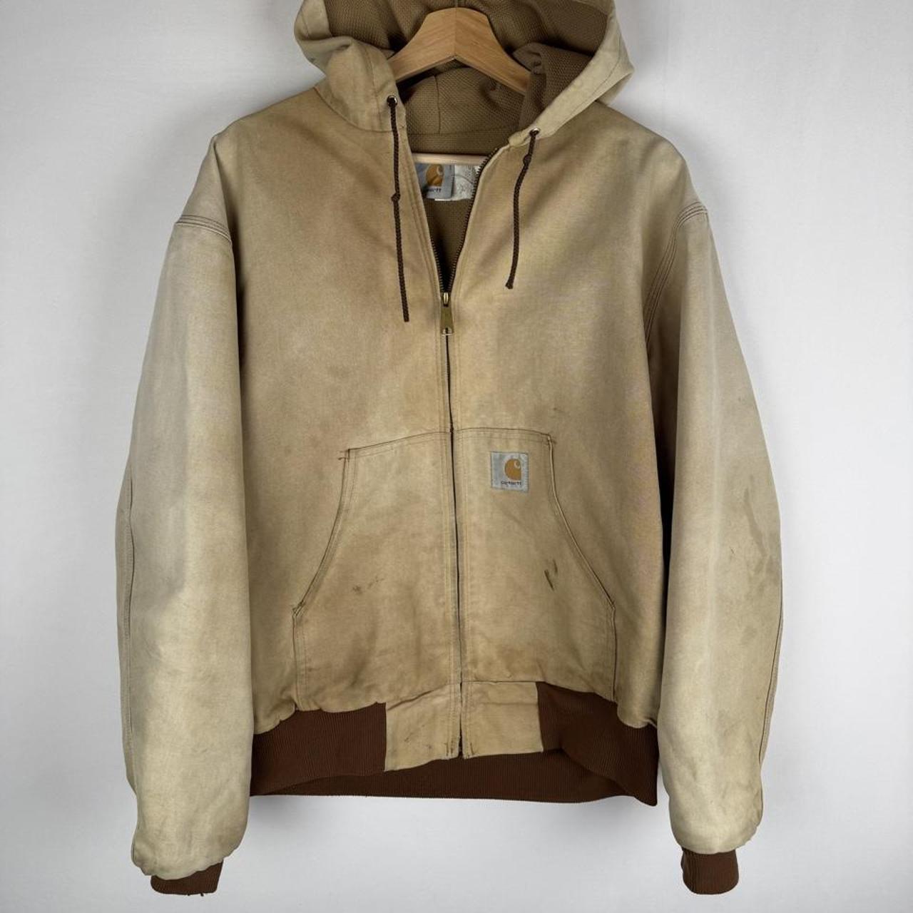 Carhartt cream distressed active jacket with logo patch and relaxed fit.