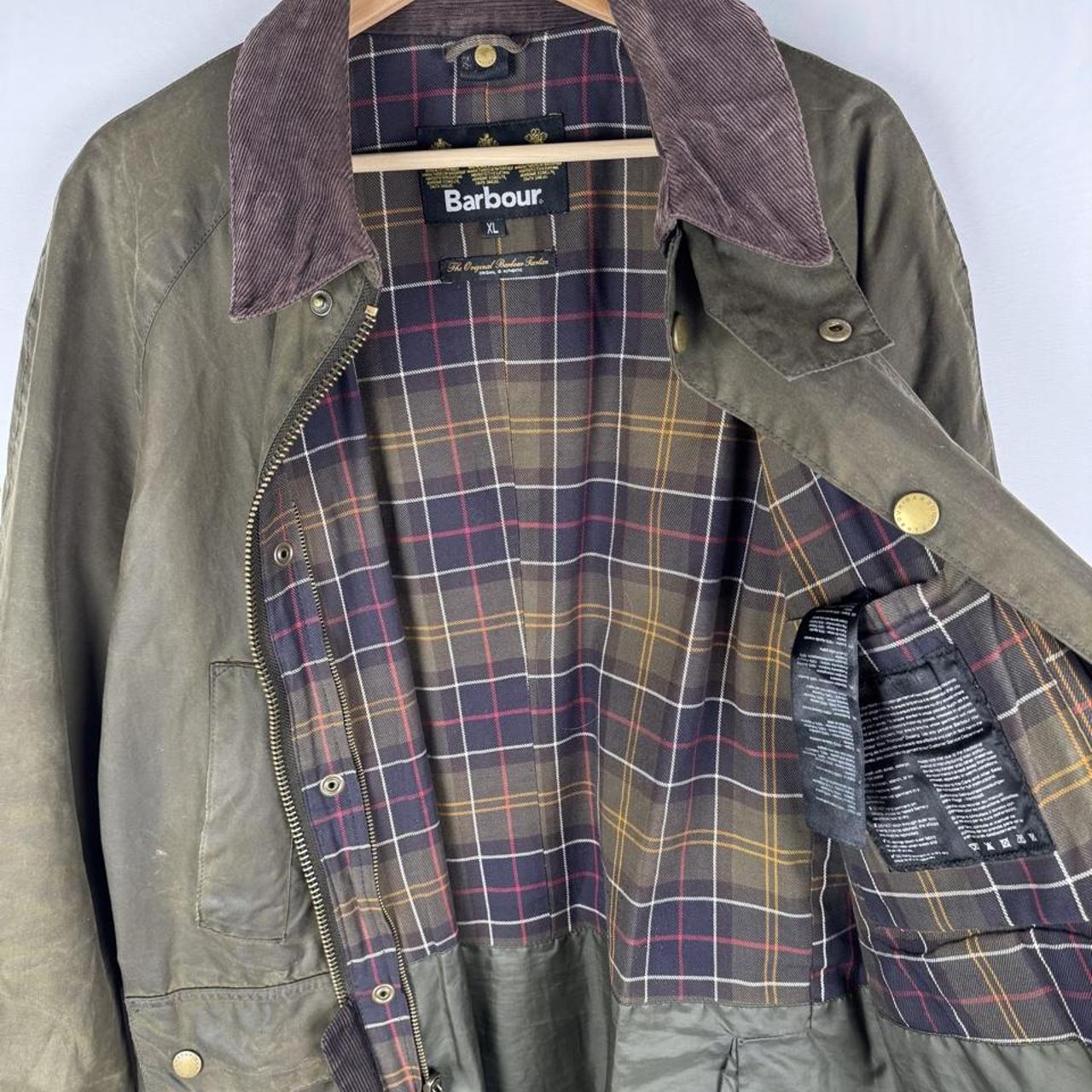 Barbour green wax jacket with logo, classic design, and durable material.