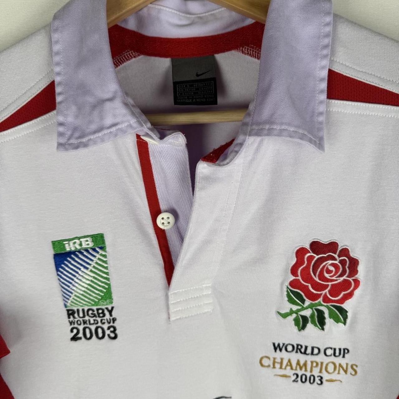 Nike men's polo shirt white with embroidered England Rugby logo and World Cup details.