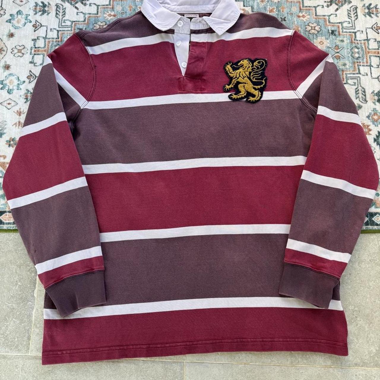Polo Ralph Lauren burgundy rugby polo shirt with embroidered athletic team logo.
