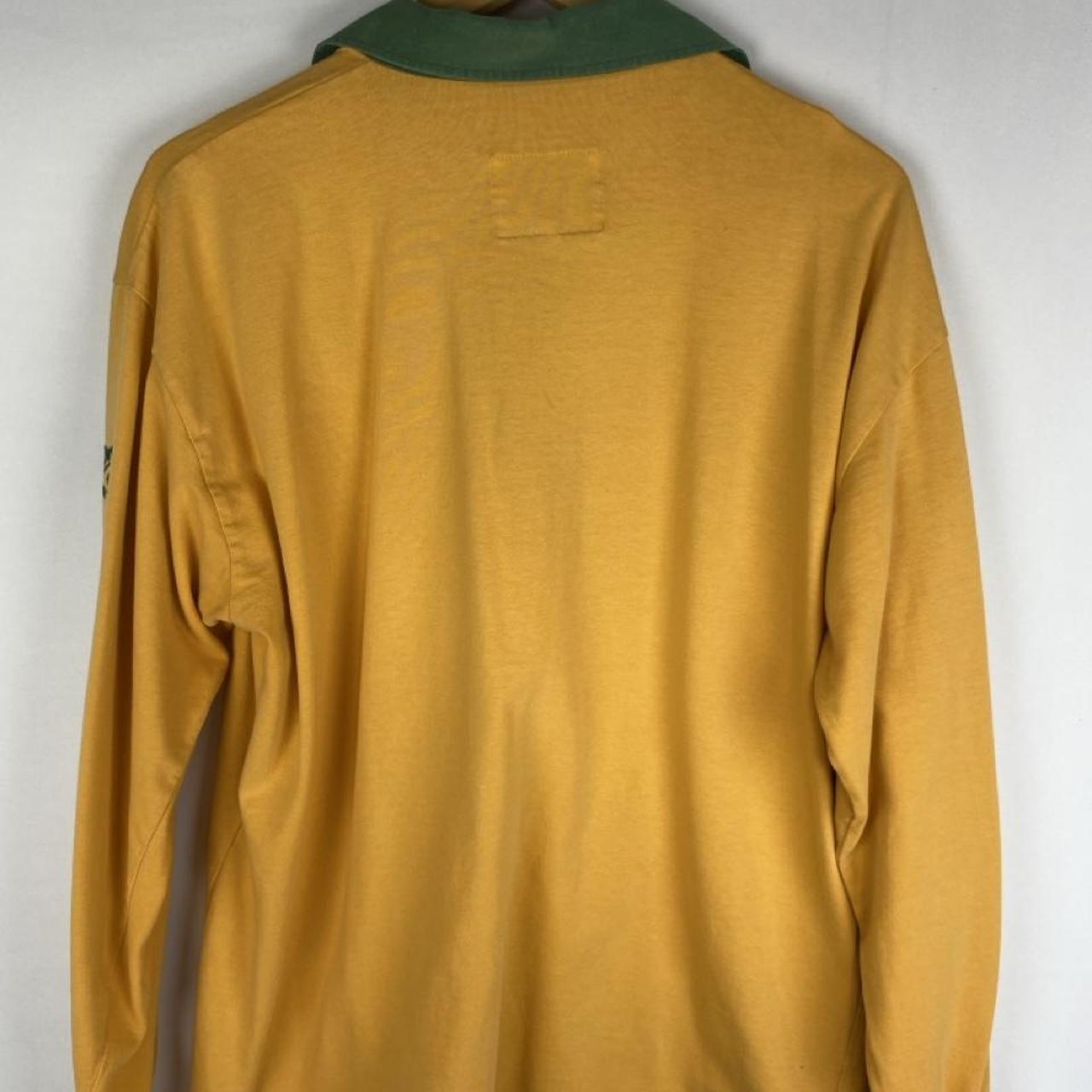 Cotton Traders green and yellow rugby polo with Wallabies logo and vintage design.