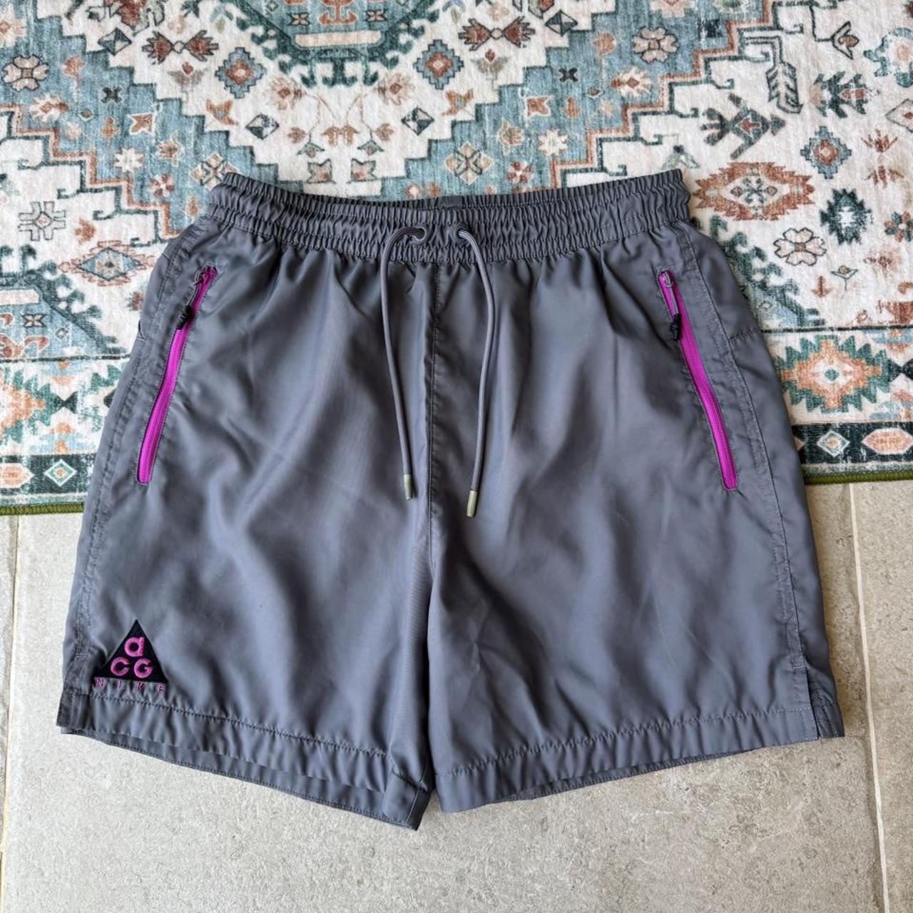 Nike ACG grey cargo training shorts with multiple pockets and logo detail.