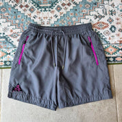 Nike ACG grey cargo training shorts with multiple pockets and logo detail.