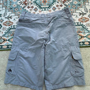 Nike ACG grey cargo shorts with multiple pockets and logo detail.