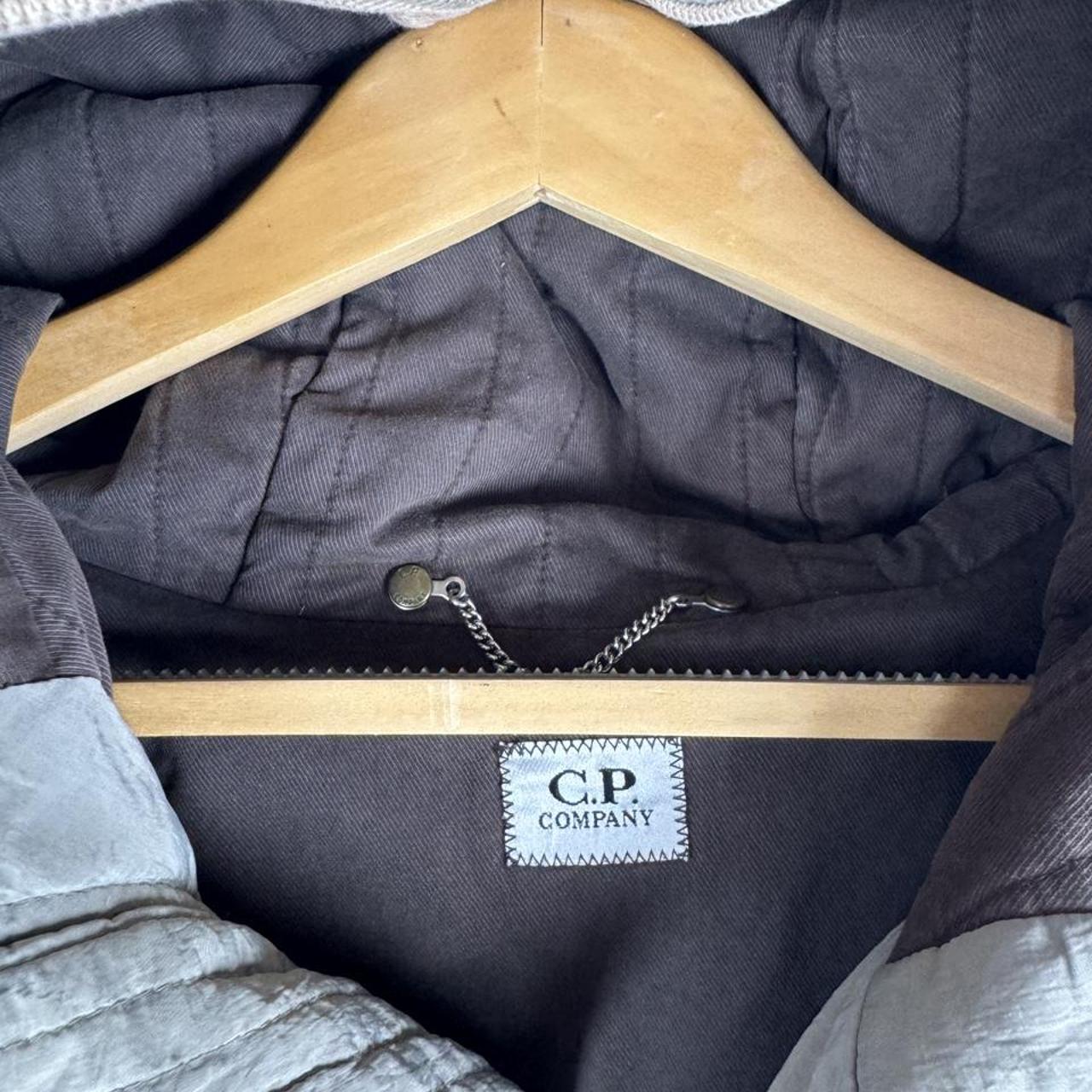 CP Company multi-colour utility parka jacket with multiple pockets and hood.