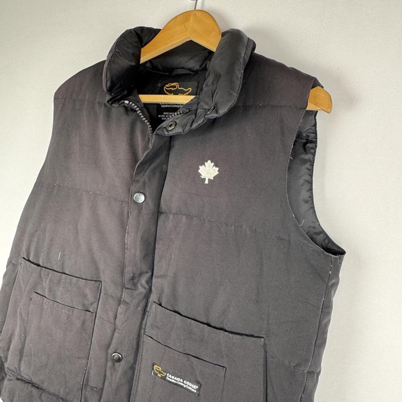 Canada Goose black down filled gilet with logo patch and zip pockets.