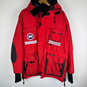 Canada Goose red parka jacket with logo patch and thick insulated material.