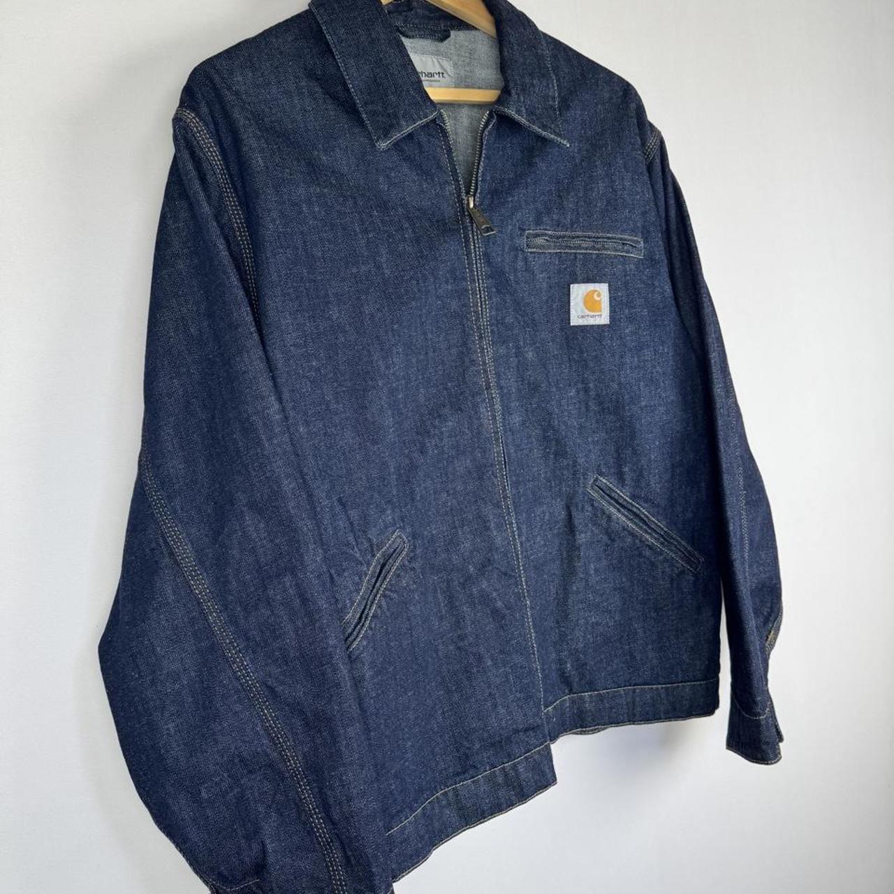 Carhartt WIP blue denim jacket with logo patch and classic design details.
