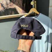 Polo Ralph Lauren navy hat with embroidered logo and adjustable strap.