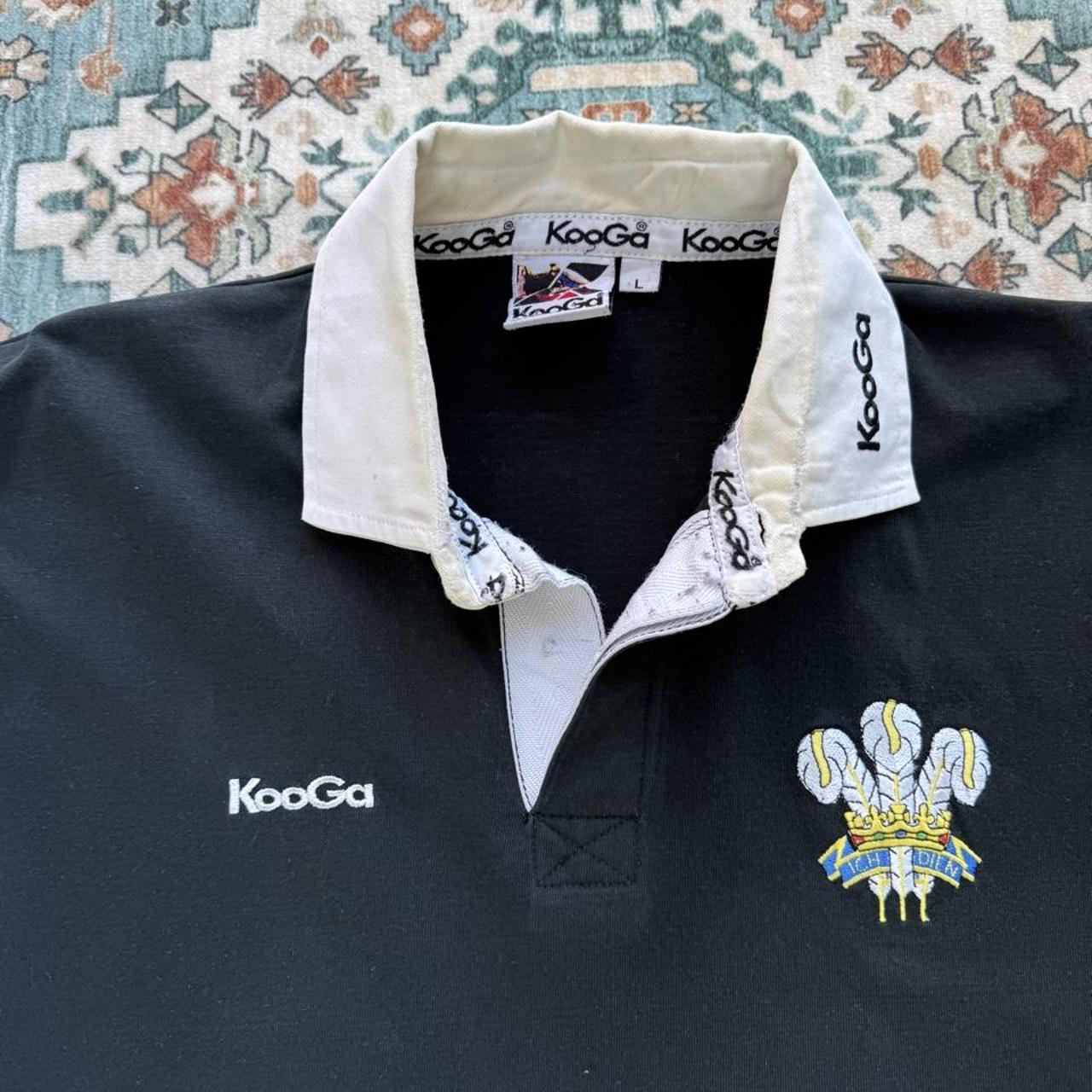 Kooga men's polo shirt in Prince of Wales pattern, featuring logo and regular fit.