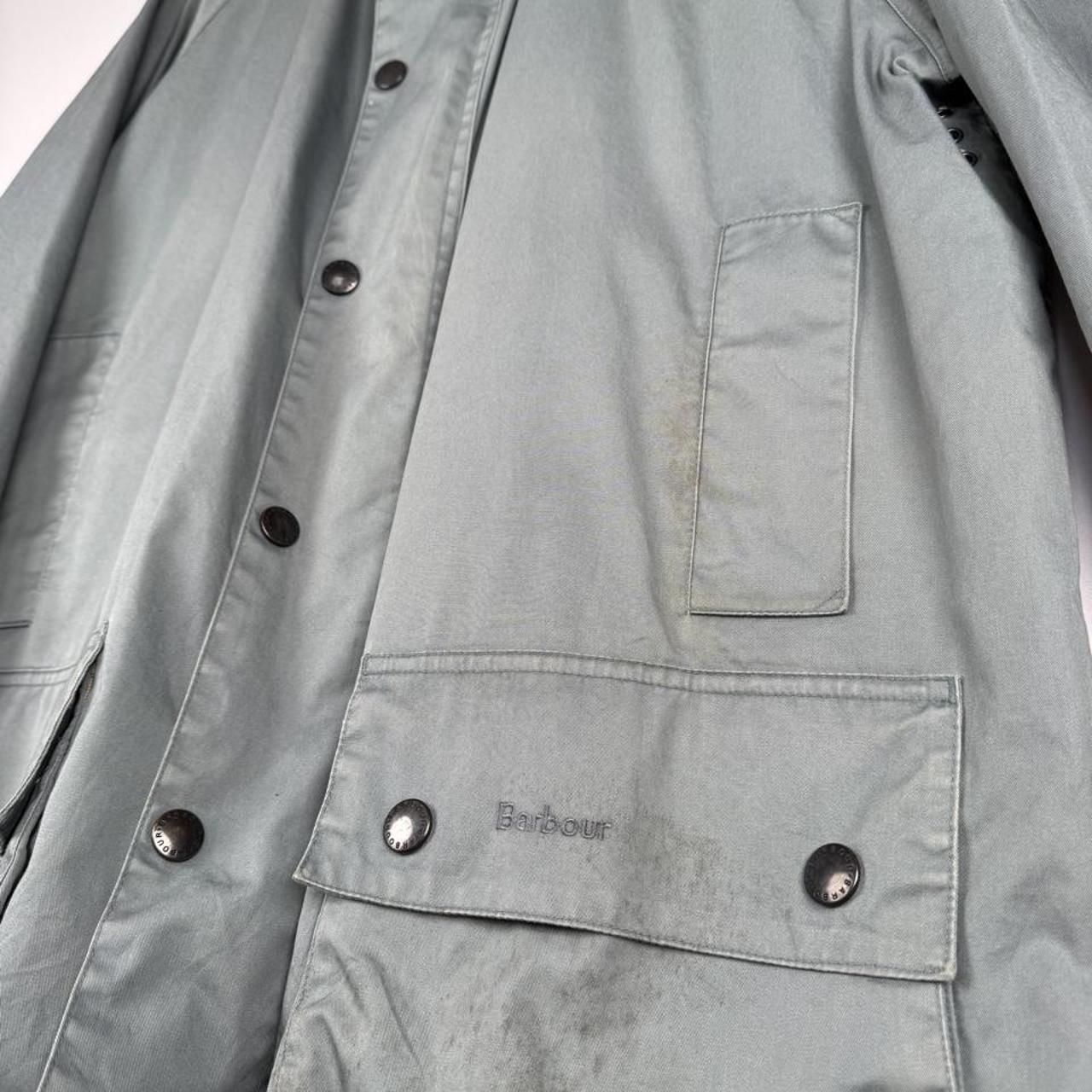 Barbour blue lightweight Beaufort jacket with subtle marks and classic logo detail.