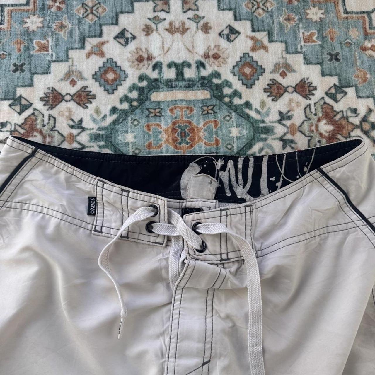 O'Neill cream board shorts with embroidered logo and relaxed baggy fit.