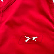 Reebok men's polo shirt red with Wales Rugby logo and slim fit design.