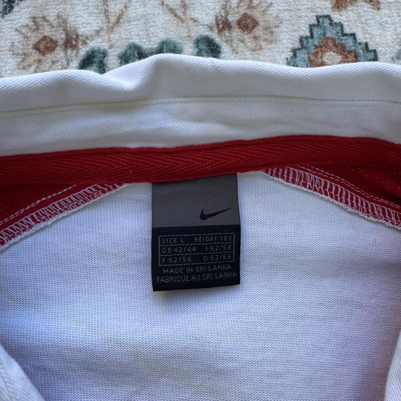 Nike England rugby polo shirt, red with embroidered logo and white collar details.