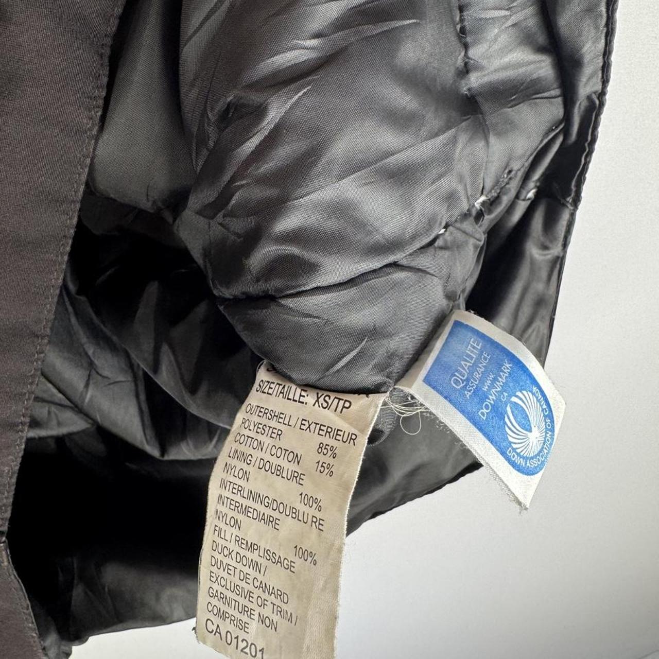 Canada Goose black down puffer gilet with logo patch and quilted texture.