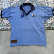 NSW Rugby League blue polo shirt with embroidered logo and vintage 1990s design.