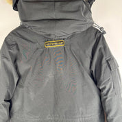 Canada Goose black parka jacket with logo patch and fur-lined hood.