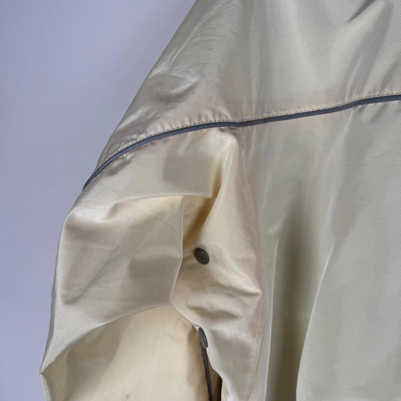 Belstaff cream motorcycle jacket with logo patch and shell material details.