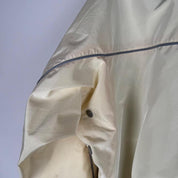 Belstaff cream motorcycle jacket with logo patch and shell material details.