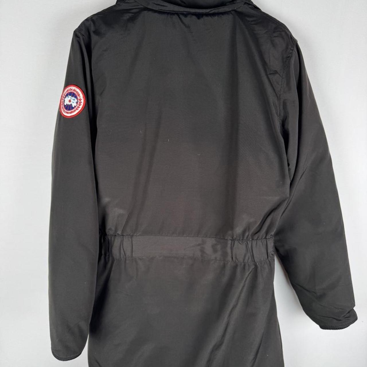Canada Goose black parka jacket with logo, slight tear near pocket, missing hood.