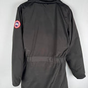 Canada Goose black parka jacket with logo, slight tear near pocket, missing hood.