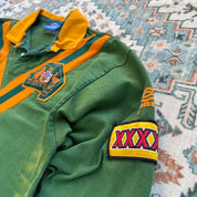 Umbro men's polo shirt green with Wallabies logo and rugby league pattern.