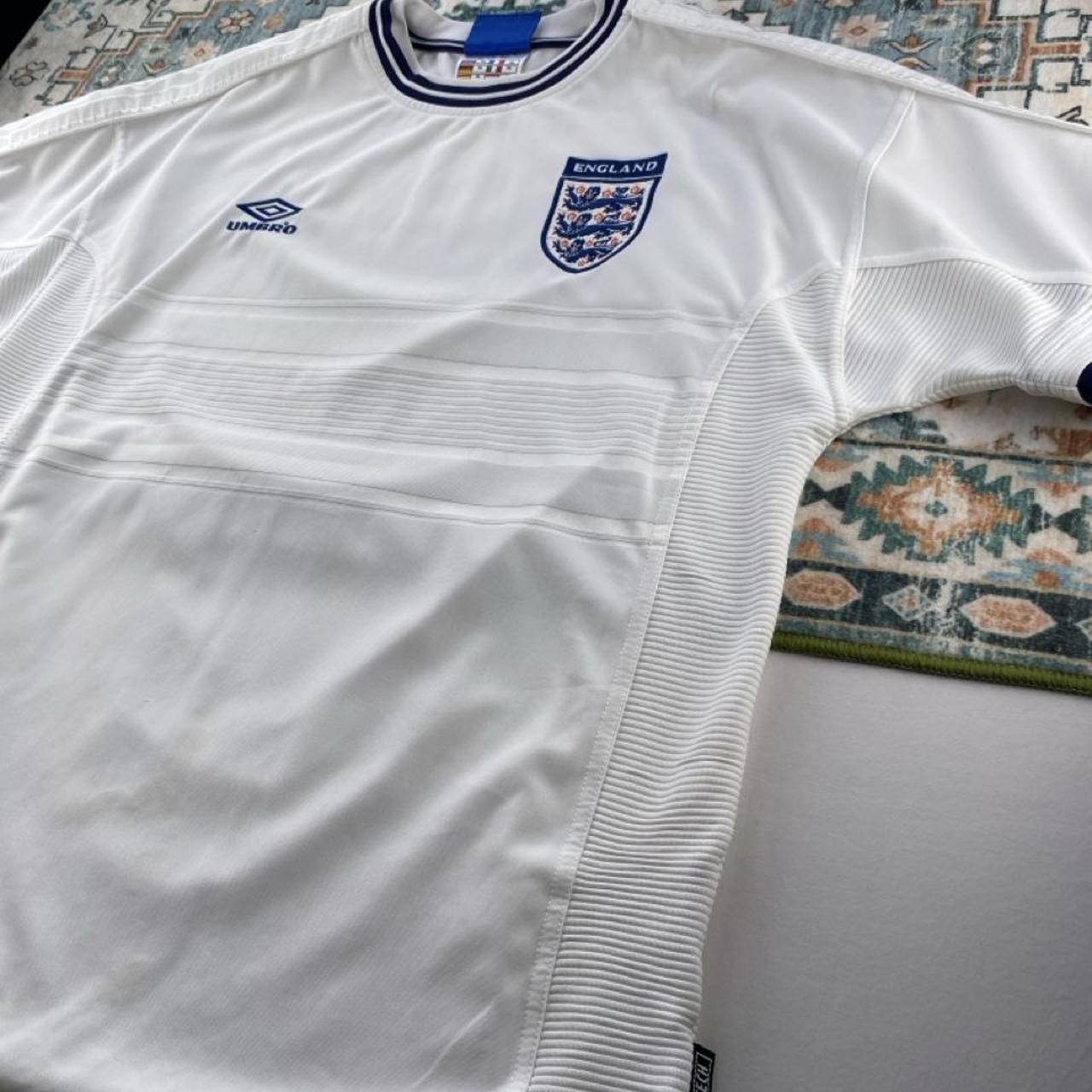Umbro England home jersey, red with white logo and classic football design.