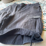 Oakley black cargo shorts with embroidered logo and tactical pockets.