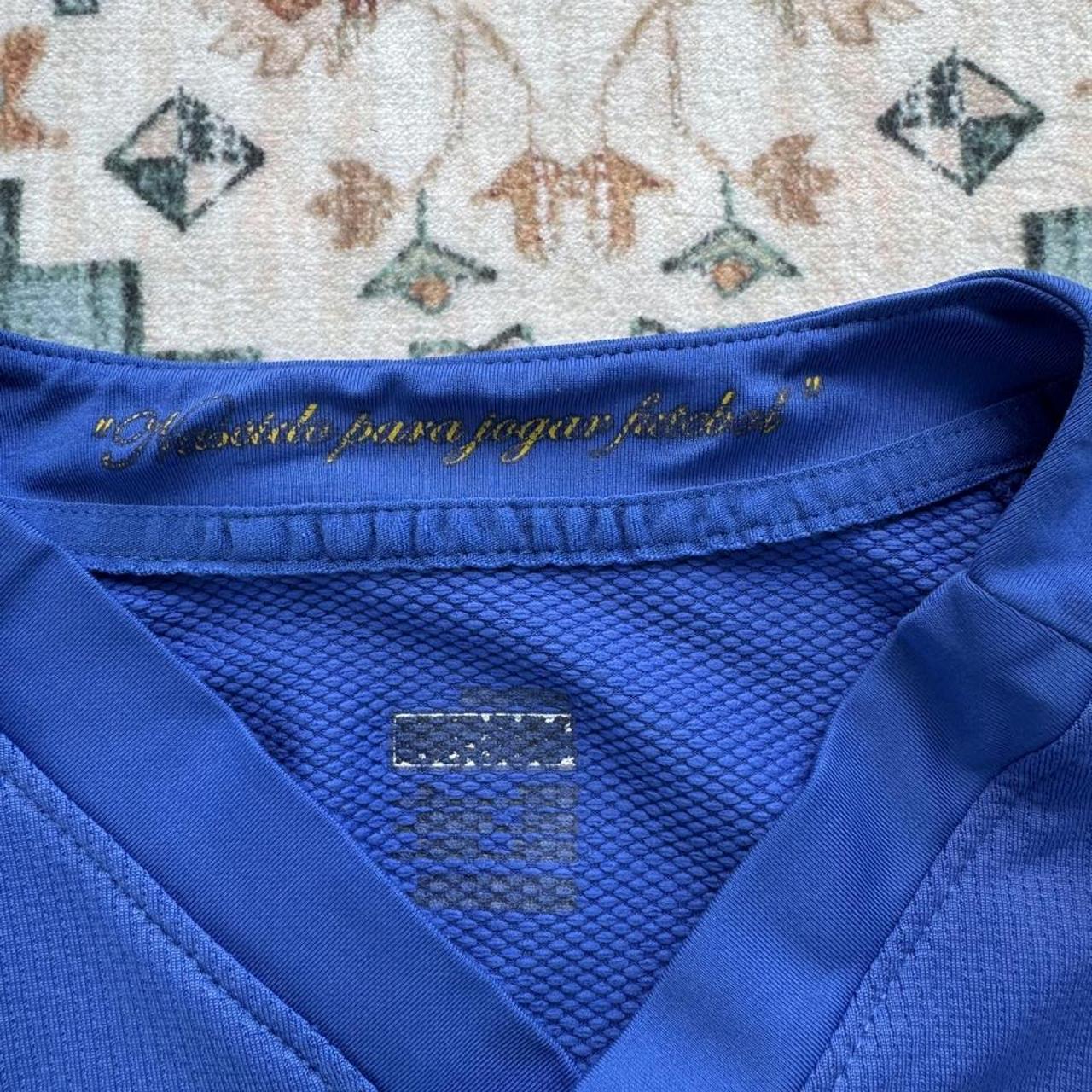Nike blue Brazil away jersey with logo and classic design details.