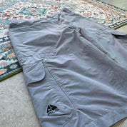Nike ACG grey cargo shorts with multiple pockets and logo detail.