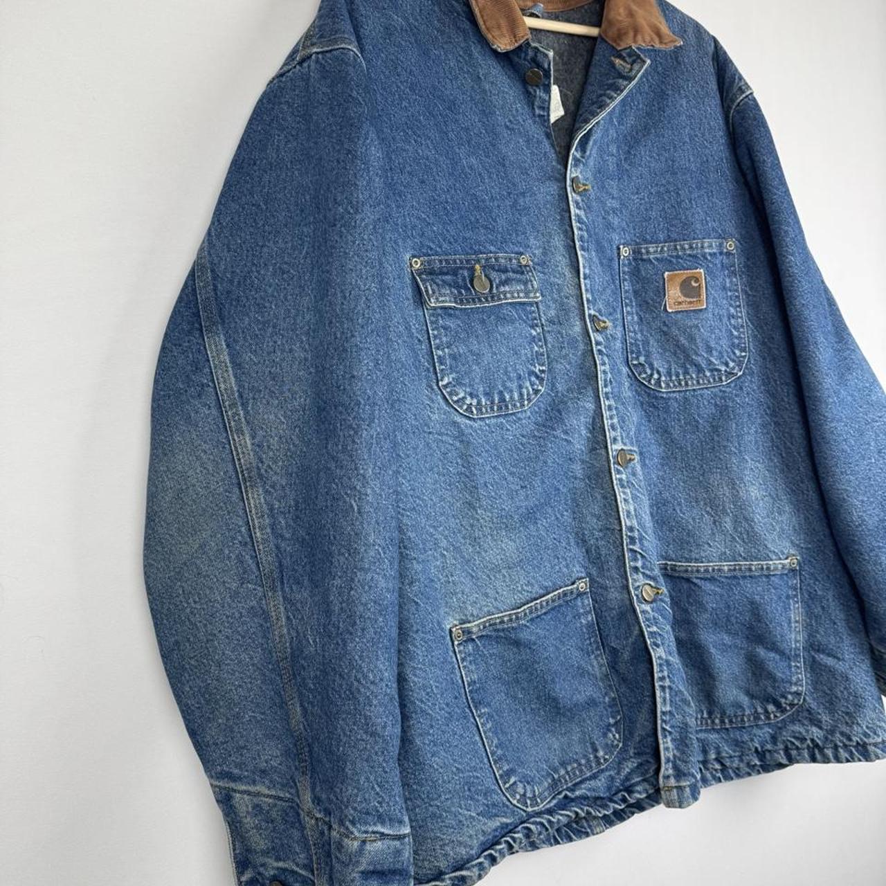 Carhartt denim chore jacket oversized 1990s style with classic logo and blue wash.