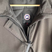 Canada Goose black parka jacket with logo, slight tear near pocket, missing hood.