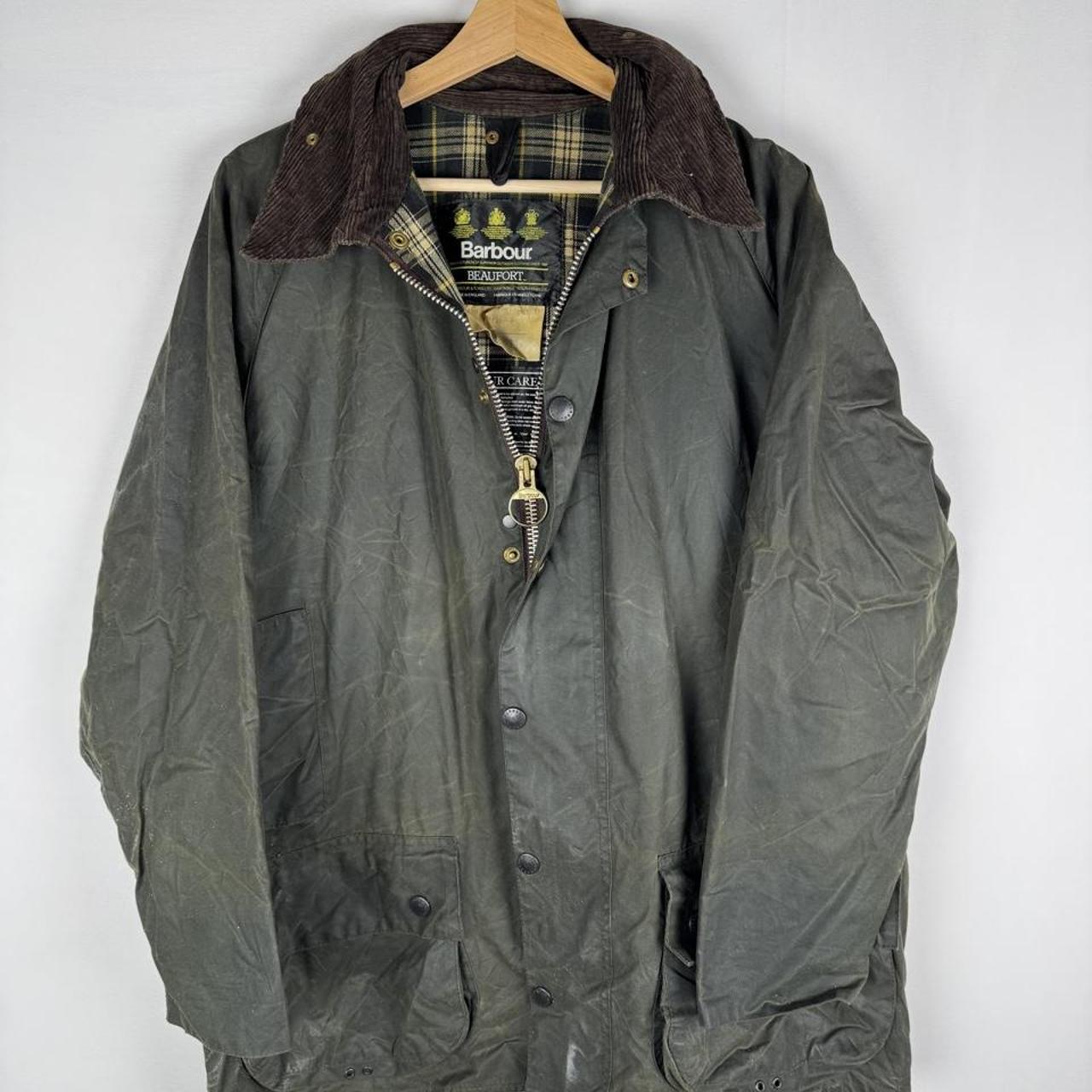 Barbour green waxed Beaufort jacket with attached hood and classic logo detail.