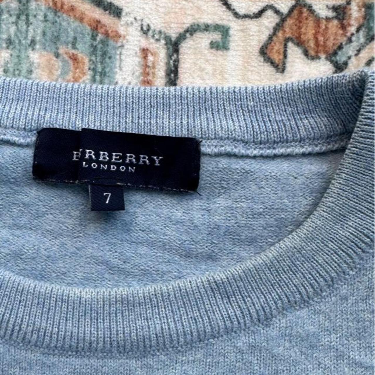 Burberry light blue knitted jumper featuring iconic check pattern and soft merino wool.