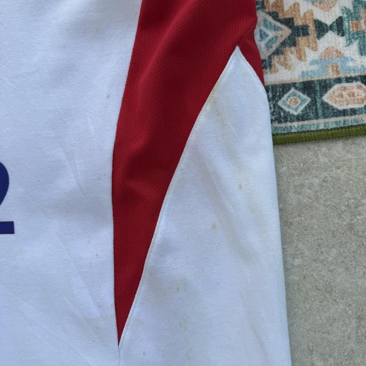 Nike England rugby polo shirt, red with embroidered logo and white collar details.