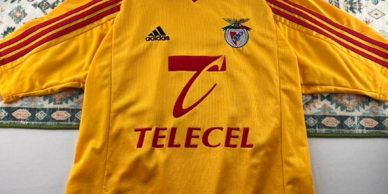 Adidas orange Benfica away jersey with embroidered logo and vintage design details.