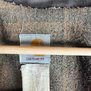 Carhartt oversized chore jacket in brown with classic logo patch and durable fabric.