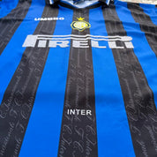 Umbro blue and navy striped home jersey with embroidered logo and vintage design.
