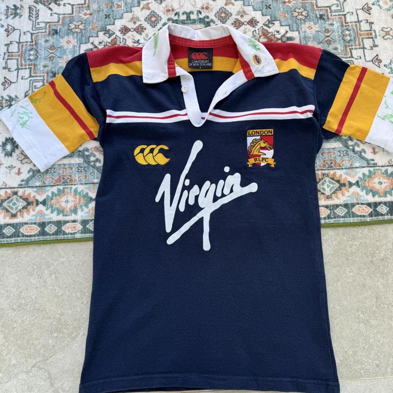 Canterbury men's polo shirt blue with embroidered London Broncos logo and signature.