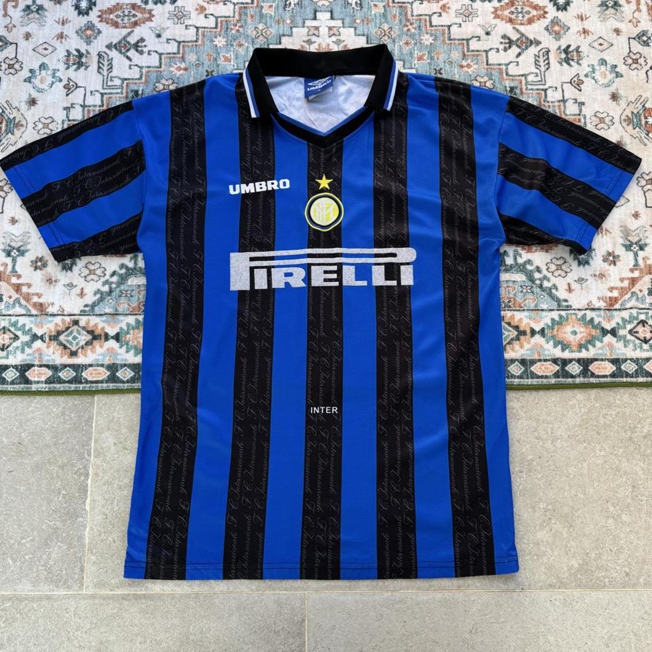 Umbro blue and navy striped home jersey with embroidered logo and vintage design.