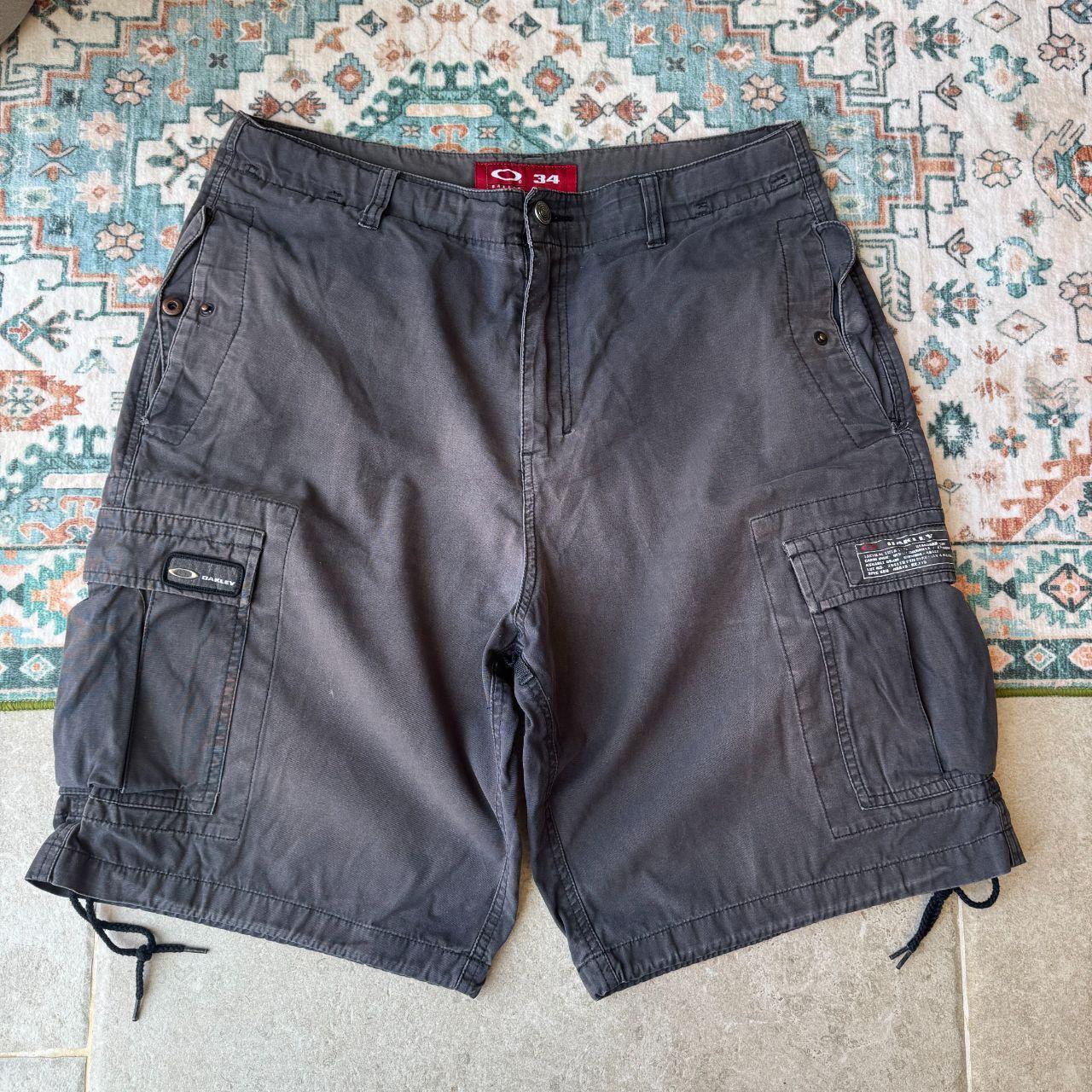 Oakley black cargo shorts with embroidered logo and tactical pockets.