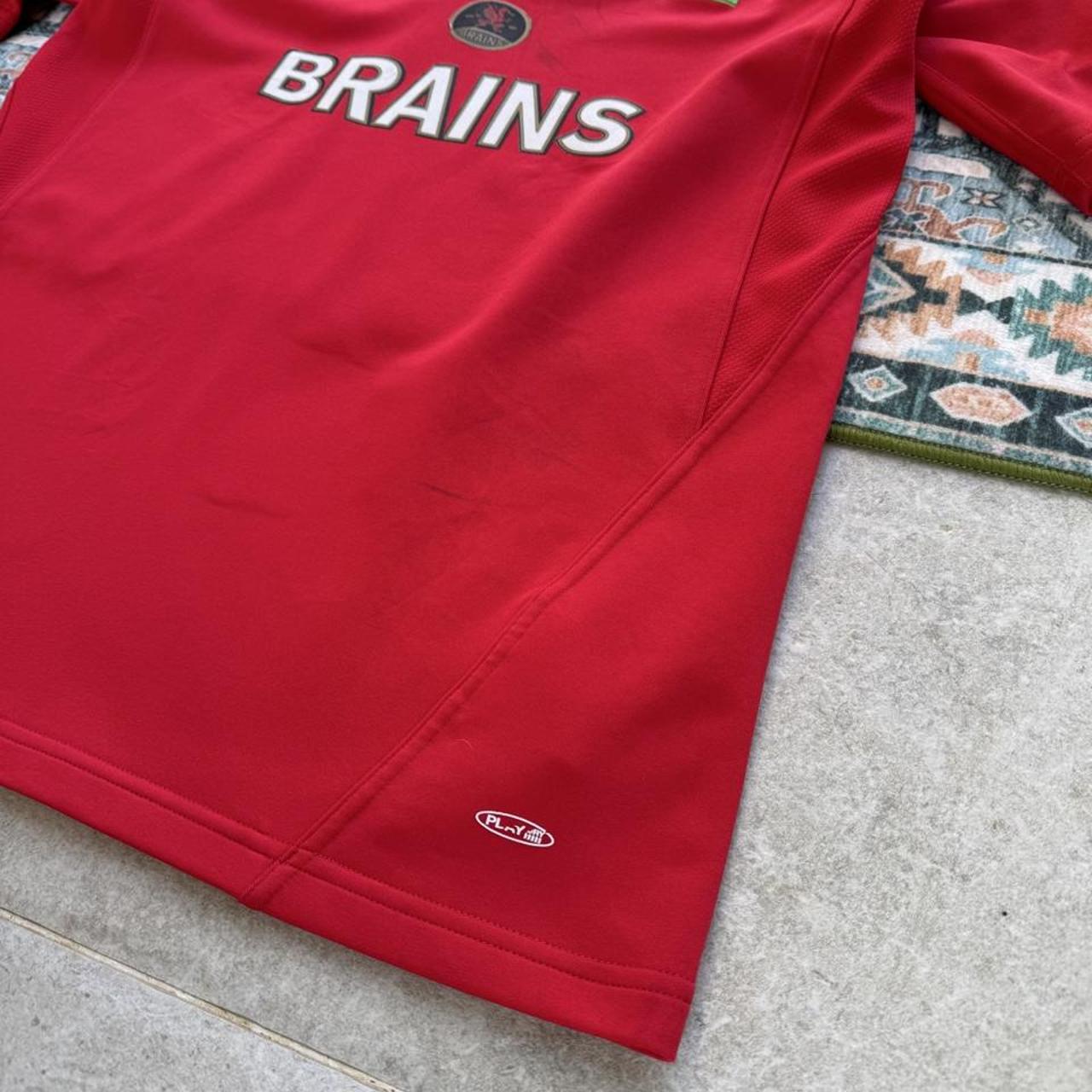Reebok men's polo shirt red with Wales Rugby logo and slim fit design.