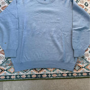 Burberry light blue knitted jumper featuring iconic check pattern and soft merino wool.